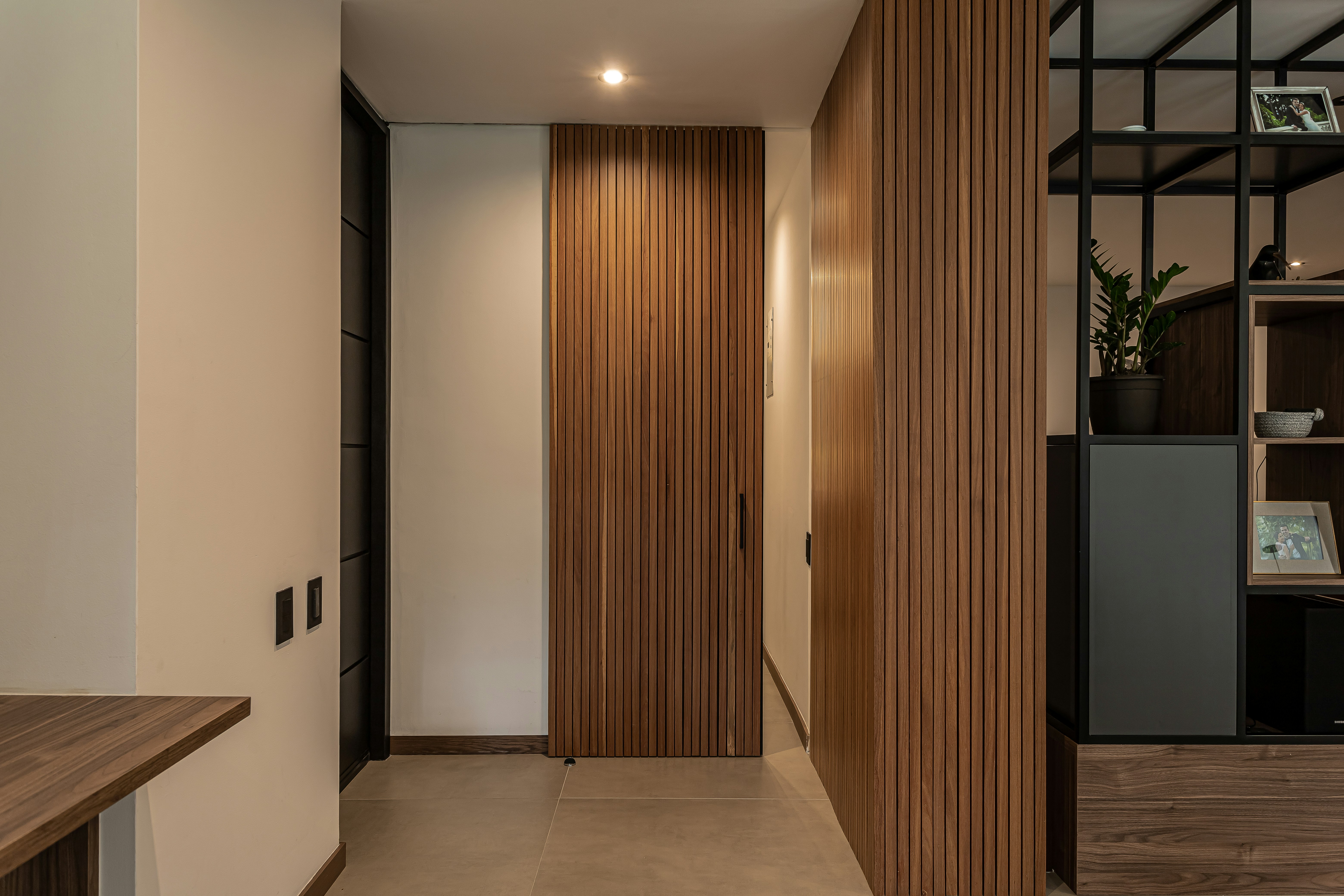Hallway with Wooden Door - Photo by <a href="https://unsplash.com/@lissetelaverdephoto?utm_content=creditCopyText&utm_medium=referral&utm_source=unsplash">Lissete Laverde</a> on <a href="https://unsplash.com/photos/a-hallway-with-a-wooden-door-and-a-shelf-lQoqUHZUdVs?utm_content=creditCopyText&utm_medium=referral&utm_source=unsplash">Unsplash</a>