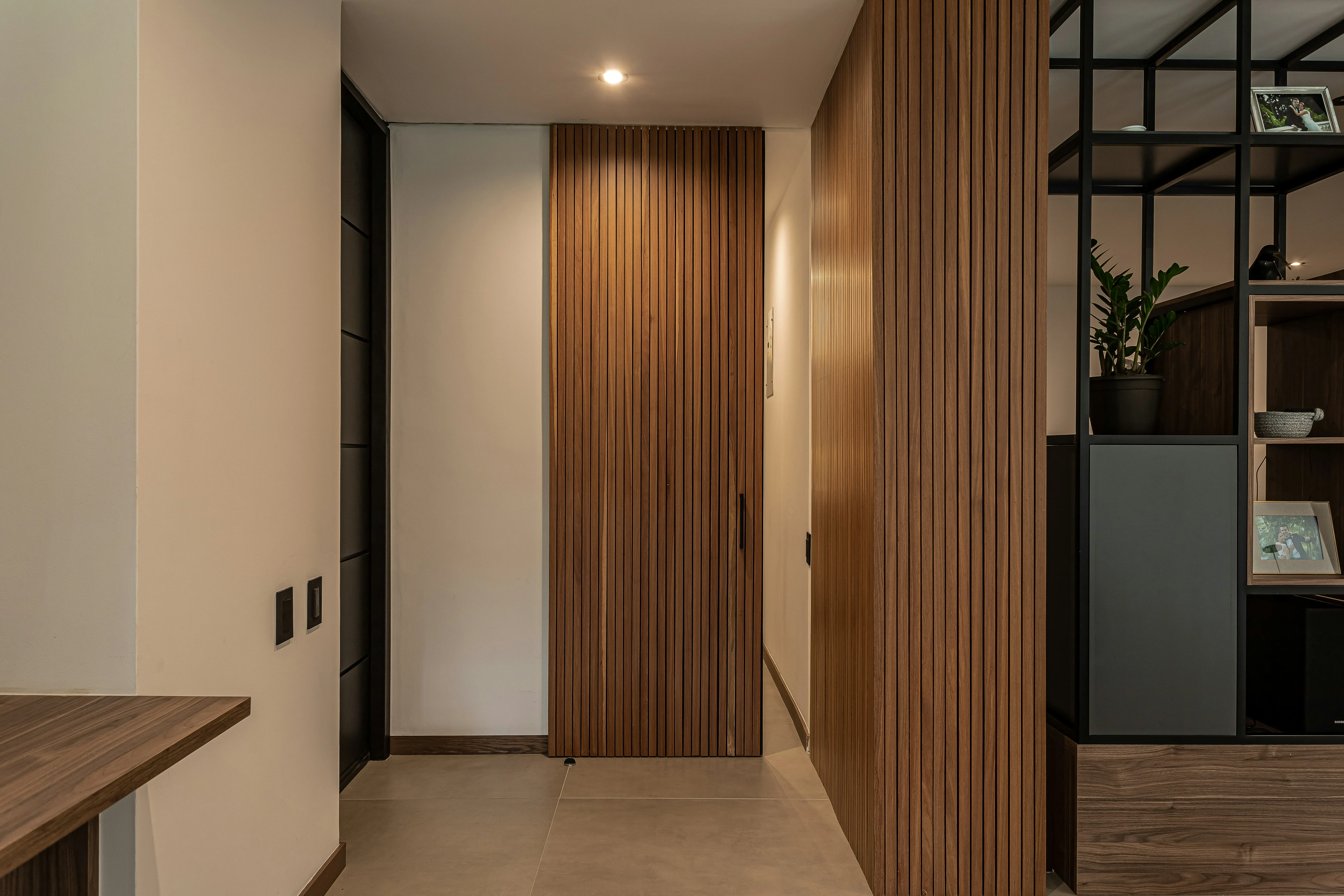 Hallway with Wooden Door - Photo by <a href="https://unsplash.com/@lissetelaverdephoto?utm_content=creditCopyText&utm_medium=referral&utm_source=unsplash">Lissete Laverde</a> on <a href="https://unsplash.com/photos/a-hallway-with-a-wooden-door-and-a-shelf-lQoqUHZUdVs?utm_content=creditCopyText&utm_medium=referral&utm_source=unsplash">Unsplash</a>
 